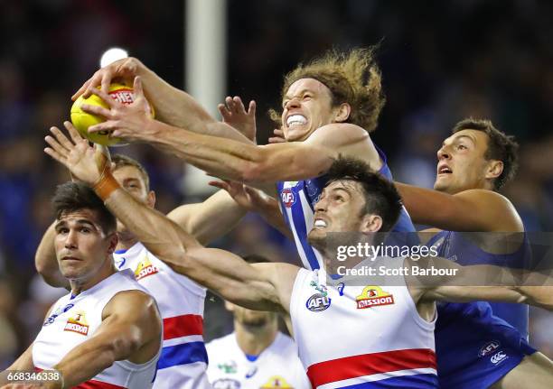 Ben Brown of the Kangaroos attempts to take a marks the ball ahead of Tom Campbell of the Bulldogs during the round four AFL match between the North...