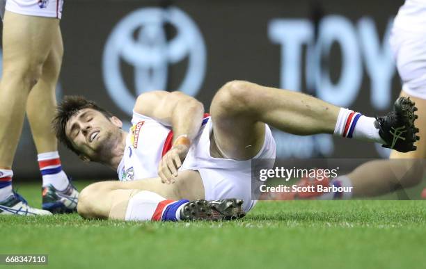 Tom Campbell of the Bulldogs leaves the field injured during the round four AFL match between the North Melbourne Kangaroos and the Western Bulldogs...