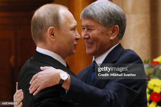 Russian President Vladimir Putin greets Kyrgyz President Almazbek Atambayev during welcoming ceremony prioir to the Sumpreme Eurasian Economic...