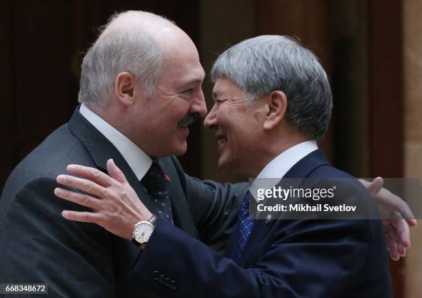 Belarussian President Alexander Lukashenko greets Kyrgyz President Almazbek Atambayev during welcoming ceremony prioir to the Sumpreme Eurasian...