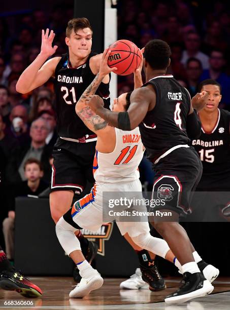 Chris Chiozza of the Florida Gators is defended by Maik Kotsar of the South Carolina Gamecocks during the second half of the 2017 NCAA Men's...