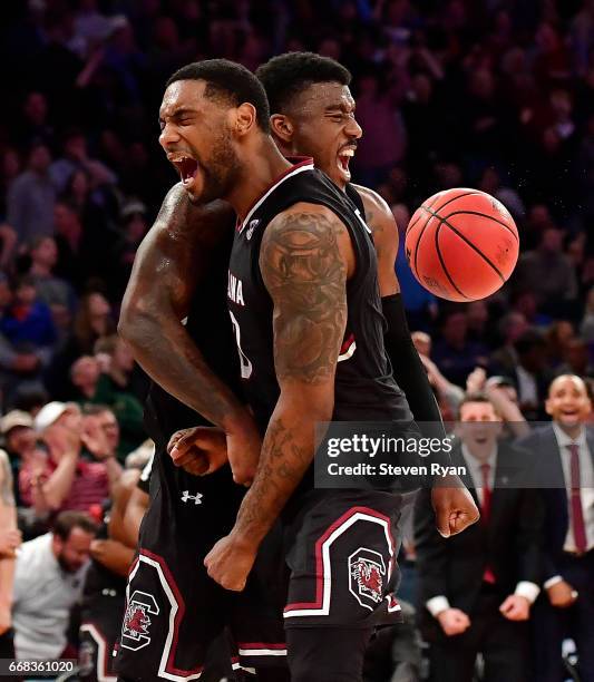 Duane Notice and Sindarius Thornwell of the South Carolina Gamecocks celebrate the play against the Florida Gators during the second half of the 2017...
