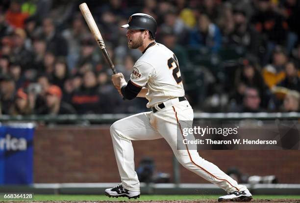 Conor Gillaspie of the San Francisco Giants hits an rbi single scoring Brandon Belt against the Arizona Diamondbacks in the bottom of the fifth...