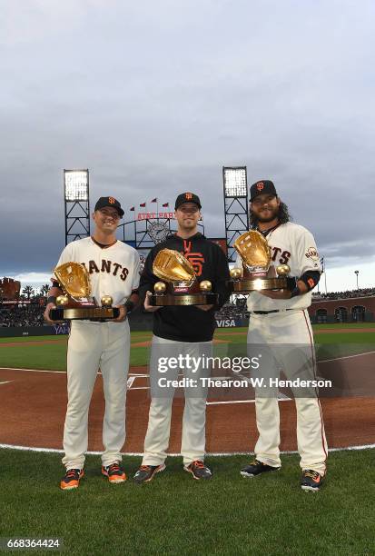 Rawlings Gold Glove winners Joe Panik, Buster Posey and Brandon Crawford of the San Francisco Giants pose together after receiving their trophies...