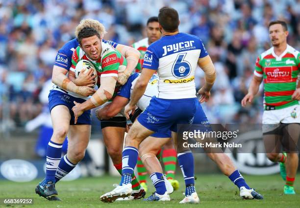 Samuel Burgess of the Rabbitohs is tackled during the round seven NRL match between the Canterbury Bulldogs and the South Sydney Rabbitohs at ANZ...