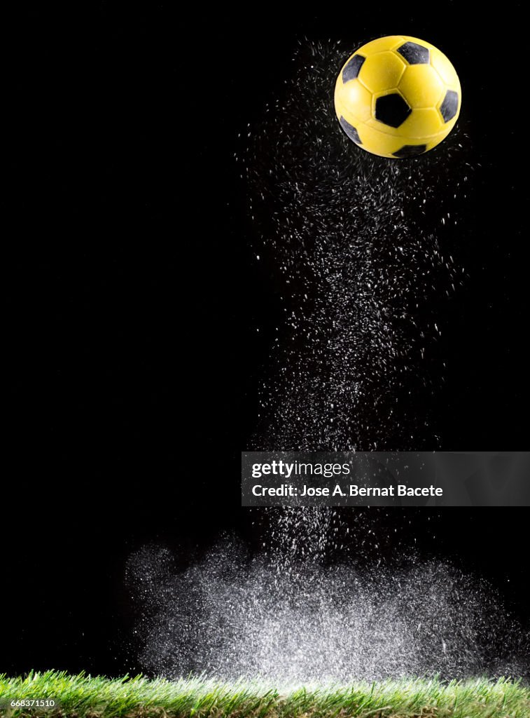 Particles of powder for the impact Ball of football in the lawn  of a soccer field