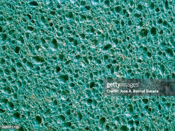 full frame of coarse and wavy textures of colored foam, blue background - agujero imagens e fotografias de stock