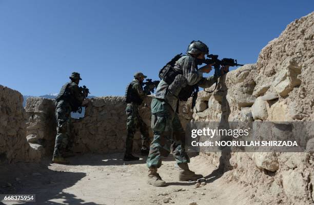 Afghan security forces take part in an ongoing operation against Islamic State militants in the Achin district of Afghanistan's Nangarhar province on...