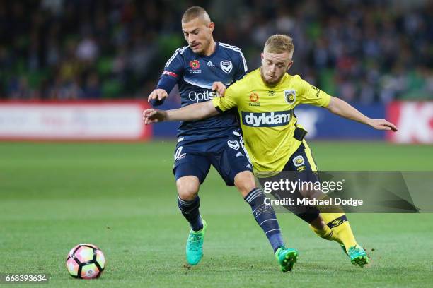 Connor Pain of the Mariners competes the ball against James Troisi of the Victory during the round 27 A-League match between the Melbourne Victory...