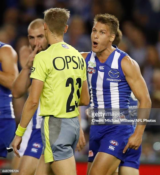Andrew Swallow of the Kangaroos speaks with Umpire Robert Findlay during the 2017 AFL round 04 match between the North Melbourne Kangaroos and the...