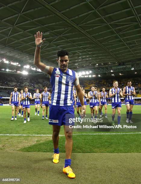 Lindsay Thomas of the Kangaroos salutes the crowd after his 200th match during the 2017 AFL round 04 match between the North Melbourne Kangaroos and...