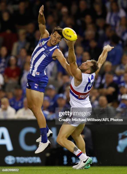 Travis Cloke of the Bulldogs and Robbie Tarrant of the Kangaroos compete for the ball during the 2017 AFL round 04 match between the North Melbourne...