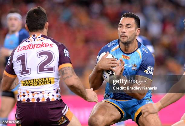 Ryan James of the Titans takes on the defence during the round seven NRL match between the Brisbane Broncos and the Gold Coast Titans at Suncorp...