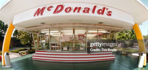 The famous golden arches and red and white tiles of McDonald's frame the two walk-up windows at the McDonald's museum July 14, 2000 in Des Plaines,...