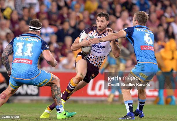 Corey Oates of the Broncos takes on the defence during the round seven NRL match between the Brisbane Broncos and the Gold Coast Titans at Suncorp...