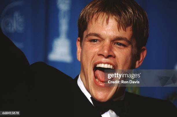 American actor Matt Damon celebrates after winning his Oscar for "Good Will Hunting" during the 70th Annual Academy Awards on March 23, 1998 at the...