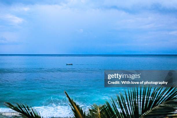 ocean coast view, blue water, blue sky horizont and palm leaves in tropical island - horizont stock pictures, royalty-free photos & images