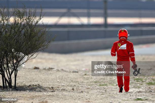 Kimi Raikkonen of Finland and Ferrari walks away after breaking down on track during practice for the Bahrain Formula One Grand Prix at Bahrain...