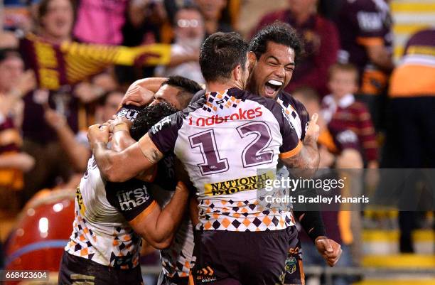 James Roberts of the Broncos is congratulated by team mates after scoring the match winning try during the round seven NRL match between the Brisbane...