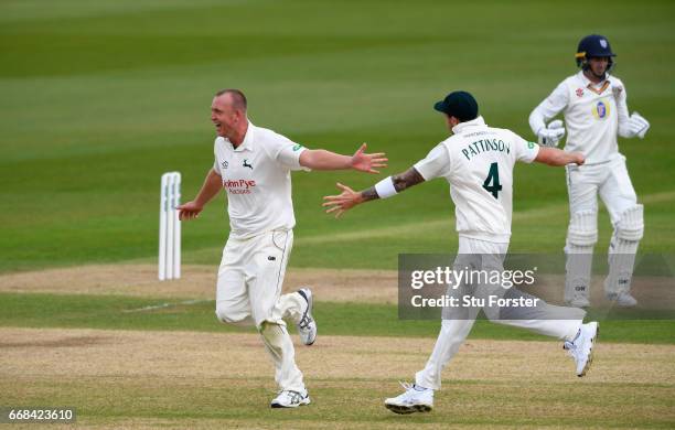 Durham batsman Michael Richardson leaves the field after being dismissed by Luke Fletcher who is congratulated by James Pattinson during day one of...