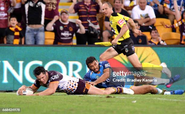 James Roberts of the Broncos dives over the tryline to score the match winning try during the round seven NRL match between the Brisbane Broncos and...