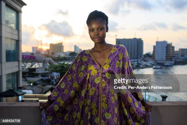Favour Lucky, winner of Nigeria"u2019s Next Super Model 2012, waits backstage between shows during the Africa International Fashion Week held on...