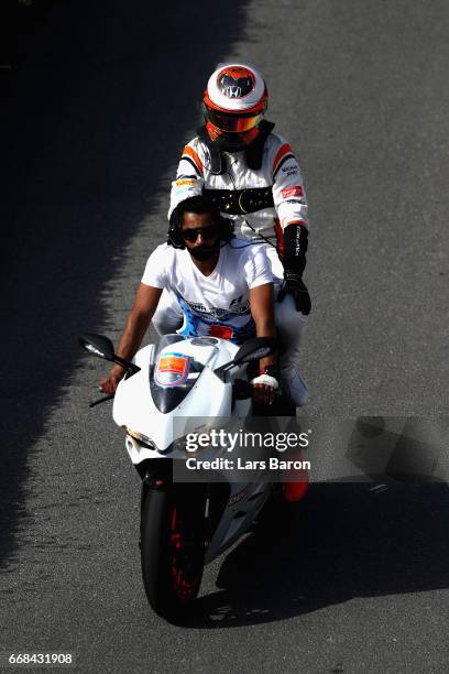 Stoffel Vandoorne of Belgium and McLaren Honda is given a lift back to the paddock after breaking down on track during practice for the Bahrain...