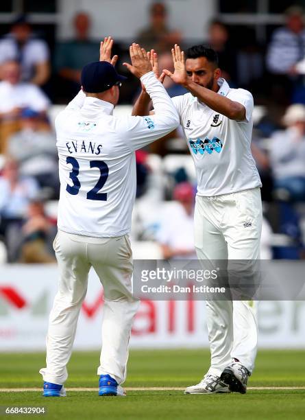 Ajmal Shahzad of Sussex celebraates with team-mates after claiming the wicket of Joe Denly of Kent during day one of the Specsavers County...
