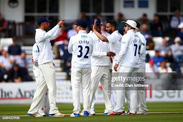 Ajmal Shahzad of Sussex celebraates with team-mates after claiming the wicket of Joe Denly of Kent during day one of the Specsavers County...