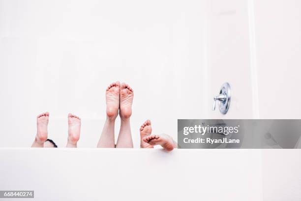 children's feet stick out of bathtub - children funny moments stock pictures, royalty-free photos & images