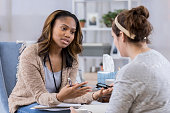 Young female counselor talks with client