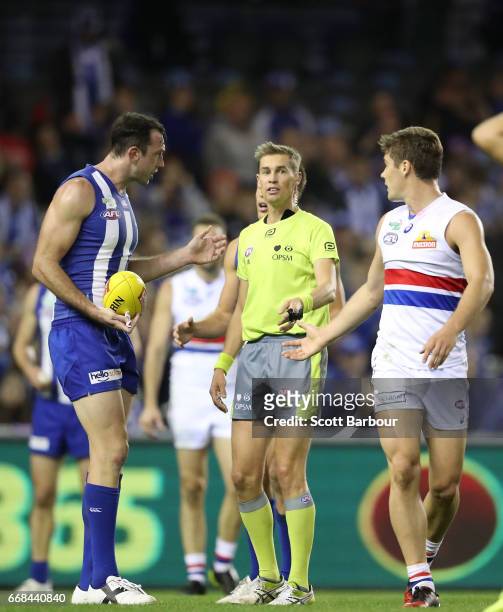 Todd Goldstein of the Kangaroos speaks with the umpires following a contentious ball up decision during the round four AFL match between the North...