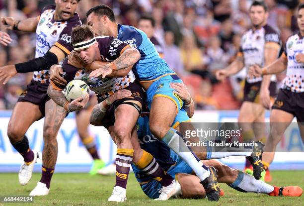 Josh McGuire of the Broncos takes on the defence during the round seven NRL match between the Brisbane Broncos and the Gold Coast Titans at Suncorp...