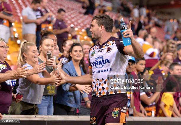 Corey Oates of the Broncos celebrates victory with fans after the round seven NRL match between the Brisbane Broncos and the Gold Coast Titans at...