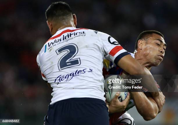 Ken Sio of the Knights is tackled by Daniel Tupou of the Roosters during the round seven NRL match between the Newcastle Knights and the Sydney...