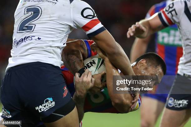 Ken Sio of the Knights is tackled by Daniel Tupou of the Roosters during the round seven NRL match between the Newcastle Knights and the Sydney...