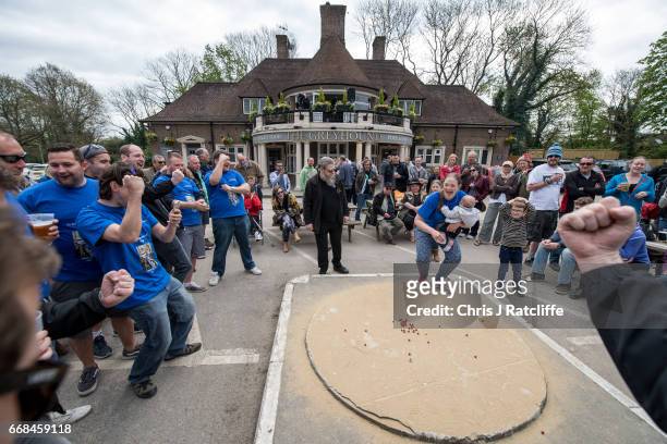 Competitor from the 'Charlwood Strikers' team reacts after taking a shot and winning a point at the World Marble Championships at the Greyhound pub...