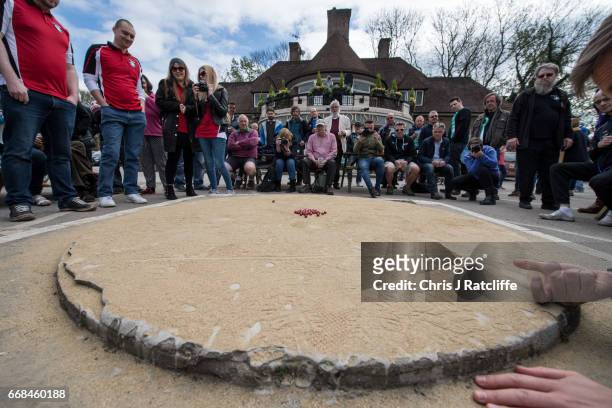 Competitor from the German '1st Murmel Club' team takes a shot at the World Marble Championships at the Greyhound pub on April 14, 2017 in Crawley,...