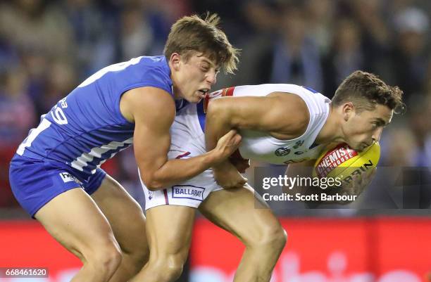 Luke Dahlhaus of the Bulldogs is tackled during the round four AFL match between the North Melbourne Kangaroos and the Western Bulldogs at Etihad...