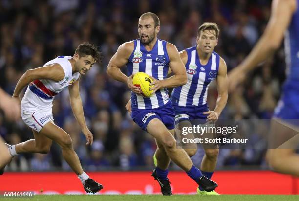 Ben Cunnington of the Kangaroos runs with the ball during the round four AFL match between the North Melbourne Kangaroos and the Western Bulldogs at...