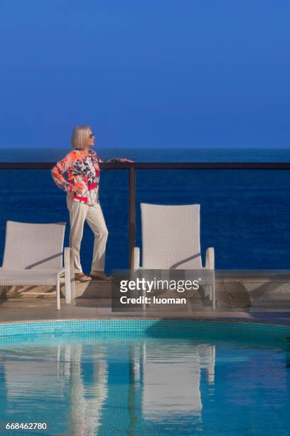elegant old lady near the swimmimg pool - roupa descontraída stock pictures, royalty-free photos & images