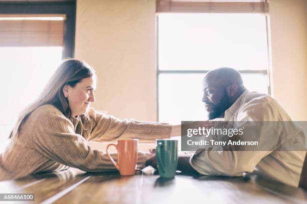 mixed race couple at home at the room dining table - supportive husband stock pictures, royalty-free photos & images