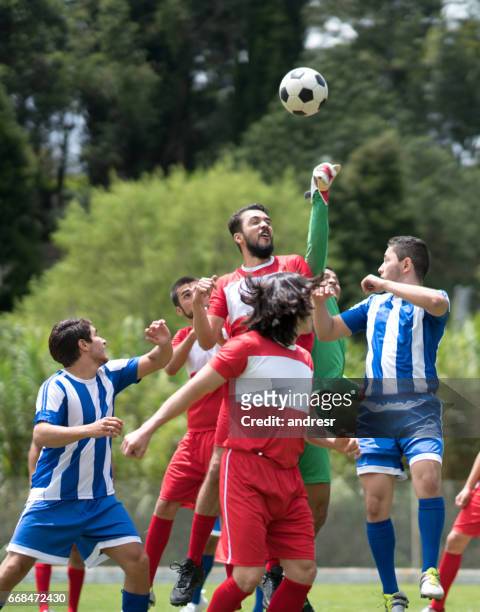 group of young men playing soccer outdoors - club football stock pictures, royalty-free photos & images