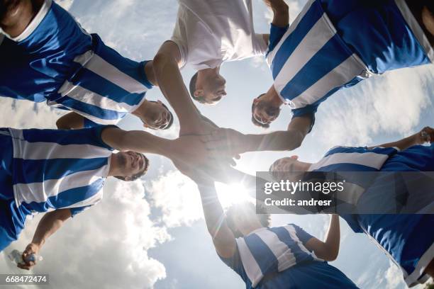 soccer team with hands together on the field - pep talk stock pictures, royalty-free photos & images