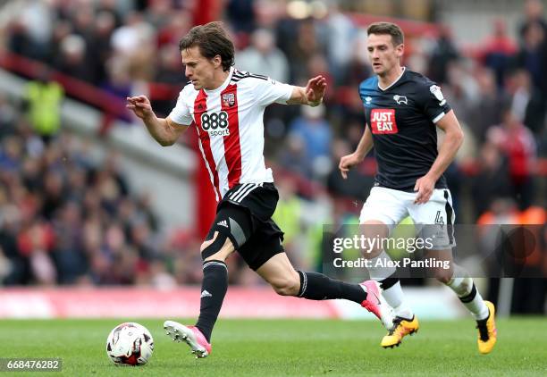 Lasse Vibe of Brentford is chased by Craig Bryson of Derby County during the Sky Bet Championship match between Brentford and Derby County at Griffin...