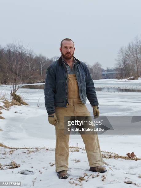 woking man standing at snowy riverbank - frozen beard stock pictures, royalty-free photos & images