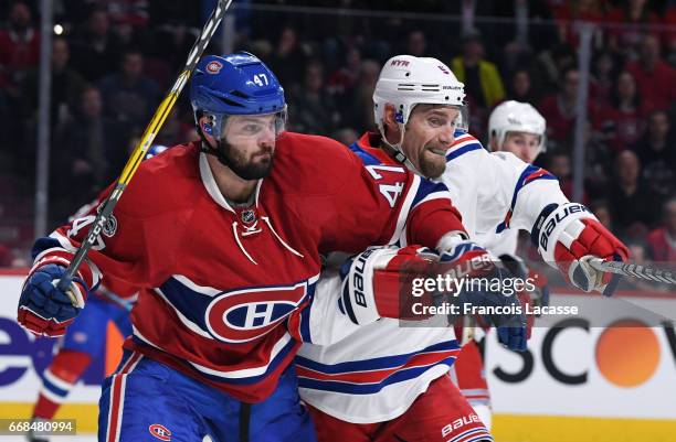 Alexander Radulov of the Montreal Canadiens battle for position against Dan Girardi of the New York Rangers in Game One of the Eastern Conference...