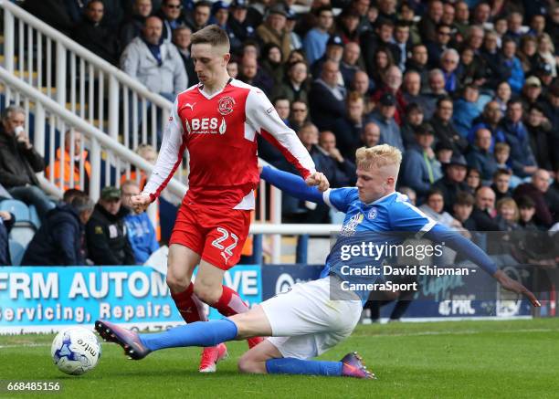 Fleetwood Town's Ashley Hunter is tackled by Peterborough United's Lewis Freestone during the Sky Bet League One match between Peterborough United...