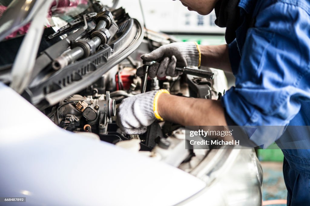 Man working in automobile restoration workshop