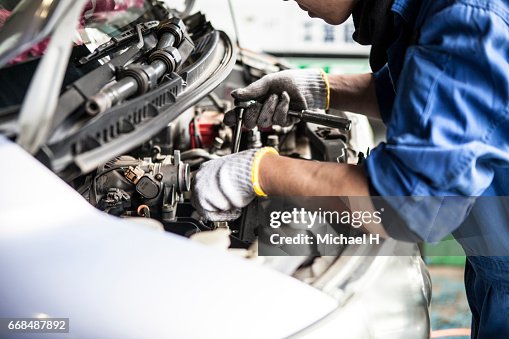 Man working in automobile restoration workshop Man working in automobile restoration workshop